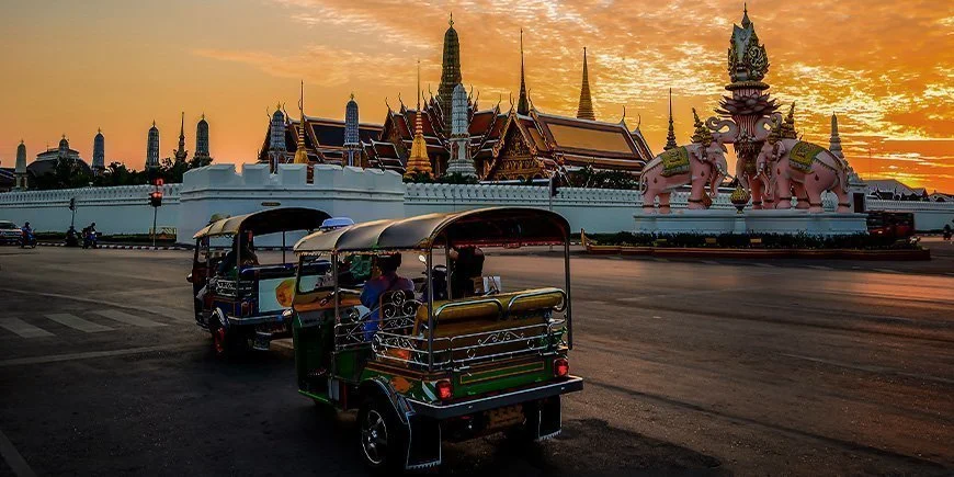 Tuk-Tuk mit Blick auf einen Tempel in Bangkok