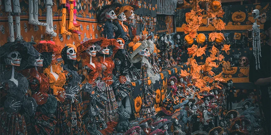 Ausstellung mit orange und schwarz gekleideten Skeletten