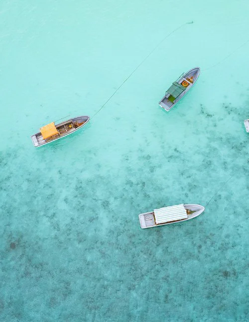 Kleine Boote auf seichtem, türkisfarbenem Wasser