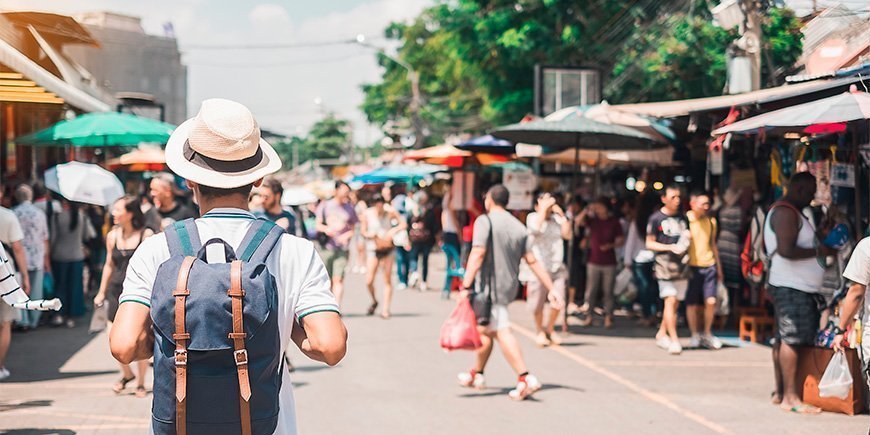 Mann beim Spaziergang auf dem Chatuchak-Wochenendmarkt in Bangkok.