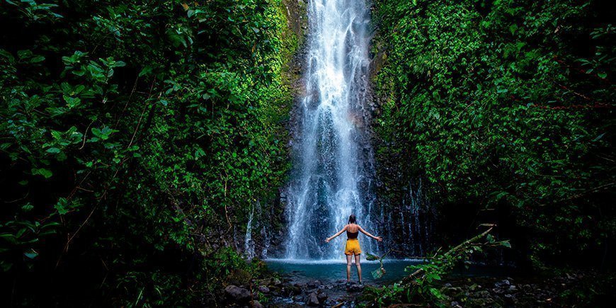 Frau vor einem Wasserfall in Costa Rica